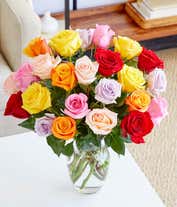 Alternative image 2 for An exquisite bouquet of roses in a kaleidoscope of colors—vivid reds, soft pinks, warm oranges, sunny yellows, and gentle purples—arranged in a clear glass vase, accompanied by a sleek bottle of rose wine from California, 2023, embodying grace and festivi