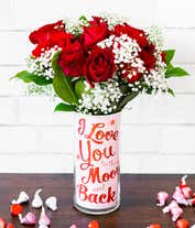 Alternative image 1 for a bouquet of 12 red roses with small white flowers and greenery in between in a clear glass vase