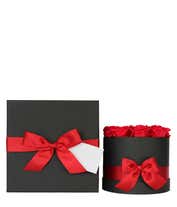 Alternative image 2 for Arrangement of vibrant red roses in a round black box, adorned with a red satin ribbon tied into a bow.