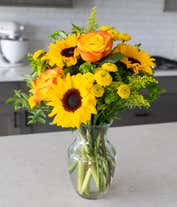 Alternative image 3 for A bouquet featuring yellow/orange bi-color roses, sunflowers, yellow button poms, yellow solidago, and bupleurum, with an optional vase.