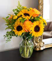 Alternative image 4 for A bouquet featuring yellow/orange bi-color roses, sunflowers, yellow button poms, yellow solidago, and bupleurum, with an optional vase.