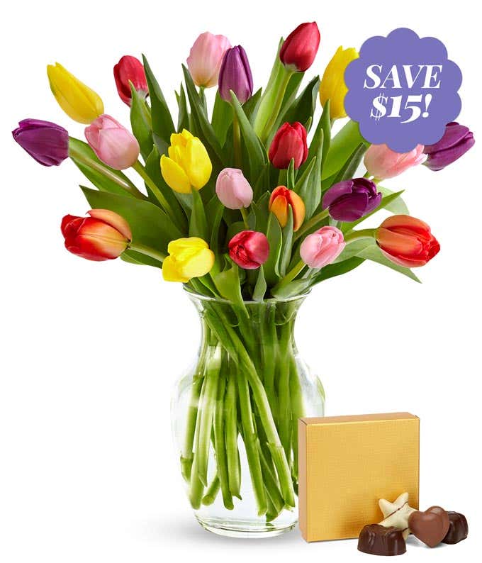 20 stems of tulips in a clear glass vase and a small gold box containing chocolates. Tulips are mixed colors, pink, purple, red, orange, yellow and white.