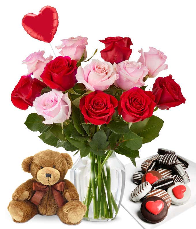 One Dozen Red & Pink Roses in a clear glass vase with red heart mylar balloon, chocolate covered valentine oreos, and a teddy bear
