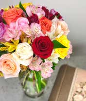 Alternative image 2 for A beautiful arrangement featuring mixed roses and assorted alstroemeria, optionally presented in a glass vase. This vibrant mix offers a colorful and cheerful display, perfect for any occasion.