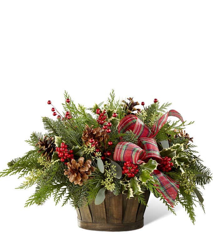 Christmas greens arranged with holly in a basket