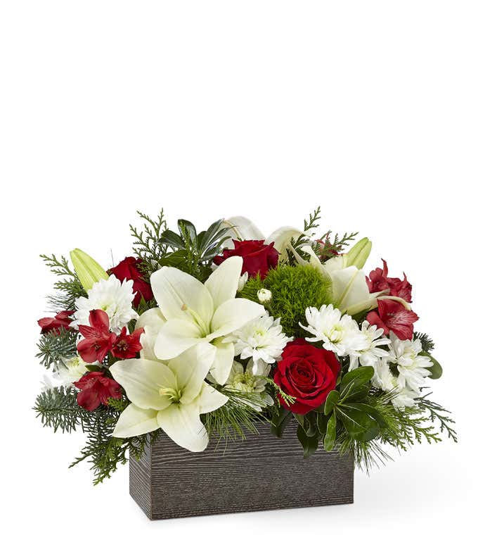 White lilies, red roses and red alstroemeria in a rectangle box.
