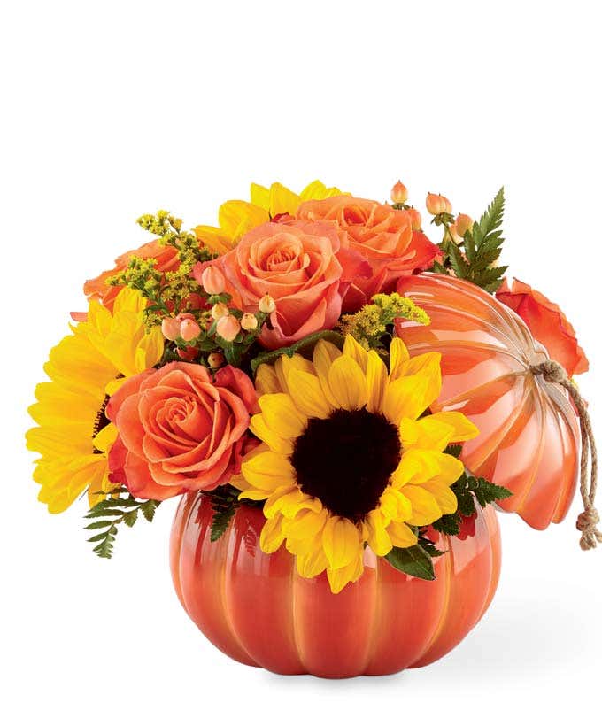 pumpkin vase with sunflowers and orange roses