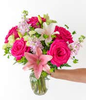 Alternative image 2 for Pink lilies, roses, and gilly flowers, with fresh floral greens in a clear glass vase