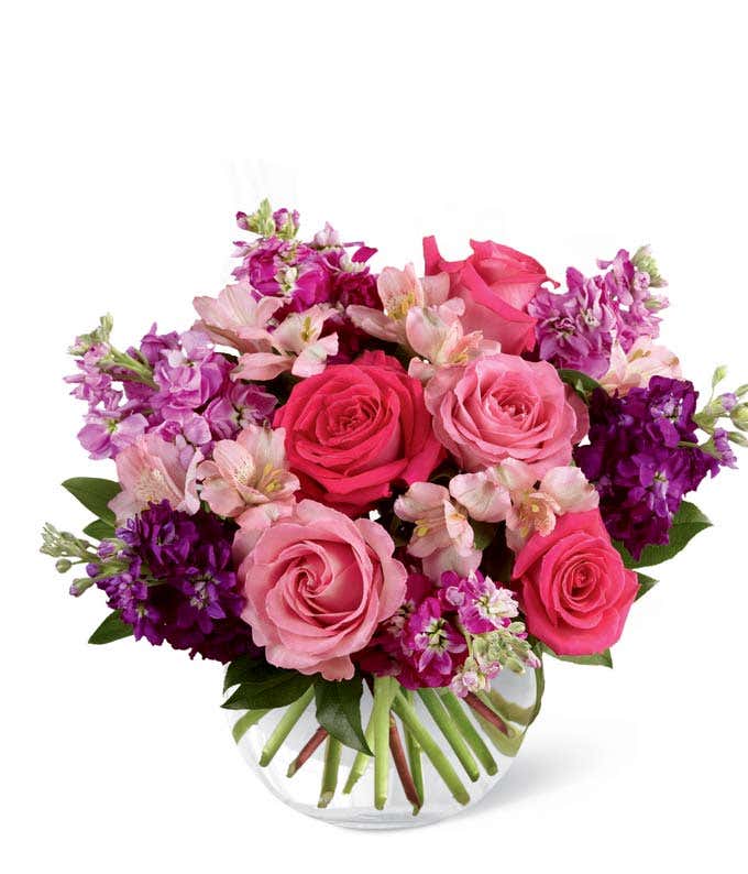 Purple flowers arranged with hot pink roses