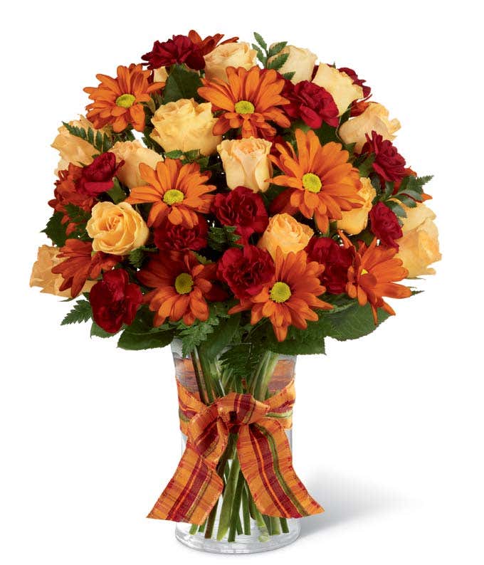 Fall flowers delivered in a glass vase, beautiful Thanksgiving flower arrangement.