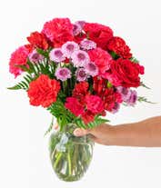 Alternative image 3 for Round, full, bouquet of red and hot pink flowers, in a clear vase