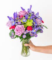 Alternative image 2 for Tall arrangement of purple roses, iris, and green and purple asters, all in a cylinder vase