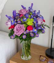 Alternative image 3 for Tall arrangement of purple roses, iris, and green and purple asters, all in a cylinder vase