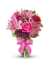Red roses, pink lilies and pink alstroemeria and glass vase