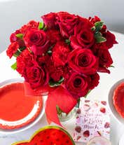Alternative image 4 for Floral arrangement featuring red roses, red carnations, red mini carnations, and a decorative red ribbon, florist delivered in a clear glass vase.