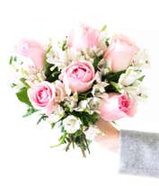 Alternative image 2 for A charming arrangement featuring pink roses and white alstroemeria, beautifully presented in a pink fluted vase with a decorative ribbon. This elegant display offers a perfect blend of colors and sophistication for any occasion.