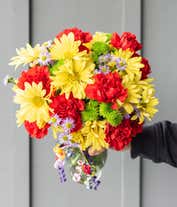 Alternative image 2 for Yellow daisies, red carnations and green button pops in a glass vase