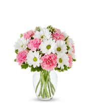Pink roses, pink carnations and white daisies in a pink vase