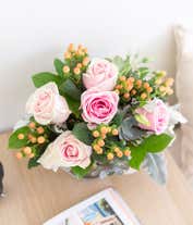 Alternative image 2 for A charming floral arrangement featuring pink roses, white lisianthus, peach berries, a succulent cutting, all beautifully arranged in a glass vase, with an option for personalization. This vibrant mix creates a stunning and unique display.
