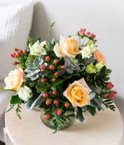 Alternative image 3 for A charming floral arrangement featuring pink roses, white lisianthus, peach berries, a succulent cutting, all beautifully arranged in a glass vase, with an option for personalization. This vibrant mix creates a stunning and unique display.