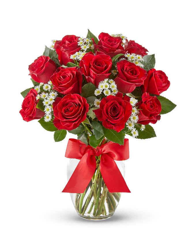 One Dozen Red Roses with monte casino in a glass vase with a red bow