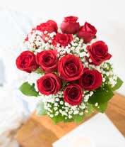 Alternative image 1 for One Dozen Red Roses with monte casino in a glass vase with a red bow