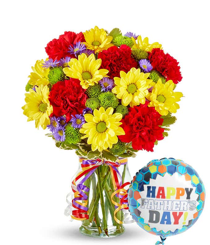 bouquet of Yellow daisies, red carnations and green button pops in a glass vase along with a happy father's day balloon