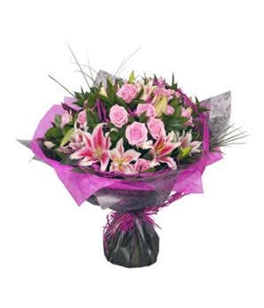 Pink roses, Pink lilies and greens in hand tied bouquet