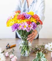 Alternative image 1 for A beautiful arrangement of seasonal flowers, elegantly presented in a glass vase. This dynamic mix of flowers changes with the seasons, offering a fresh and ever-changing display throughout the year.