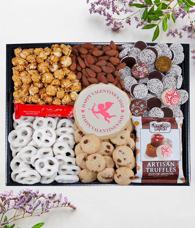 Valentine's Day gift box with caramel popcorn, yogurt pretzels, almonds, artisan truffles, patterned chocolates, chocolate chip cookies, a Lindt bar, and a cupid cookie.