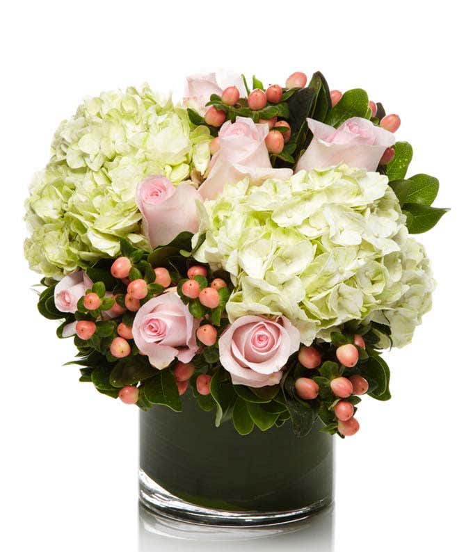 Pink roses, green hydrangea and hypericum berries