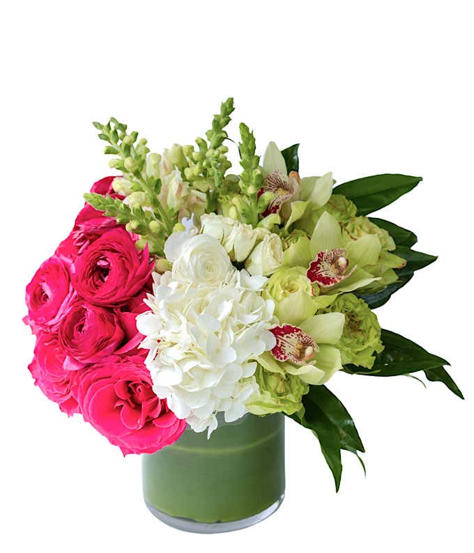 Premium flowers of pink, white, and green arranged into a leaf lined vase.
