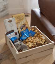 Alternative image 2 for A gourmet gift basket with assorted chocolates and treats, including Lindt Lindor truffles, Marich dark chocolate sea salt caramels, French truffles, Ghirardelli dark chocolate sea salt caramel squares, chocolate-covered cookies, caramel popcorn, and more