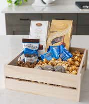 Alternative image 3 for A gourmet gift basket with assorted chocolates and treats, including Lindt Lindor truffles, Marich dark chocolate sea salt caramels, French truffles, Ghirardelli dark chocolate sea salt caramel squares, chocolate-covered cookies, caramel popcorn, and more