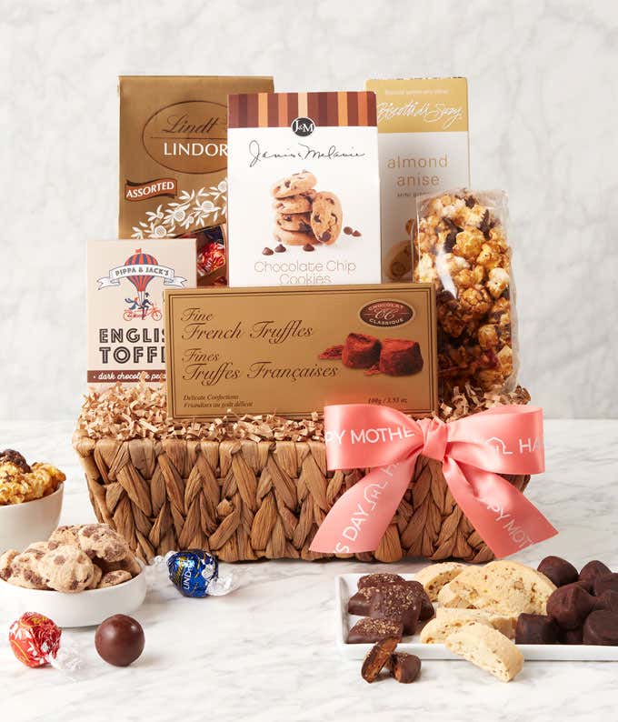 A Mother's Day gift basket filled with decadent treats including Dark Chocolate Rum Pecan English Toffee, Almond Anise Mini Biscotti, Chocolate French Truffles, Lindt Lindor Assorted Truffles, Chocolate Chip Cookies, and Chocolate Caramel Corn, presented 