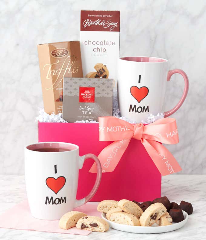 A Mother's Day gift set featuring Chocolate Chip Biscotti, a Mom Mug, French Truffles, Earl Grey Tea, all presented in a charming gift basket with a personalized message.