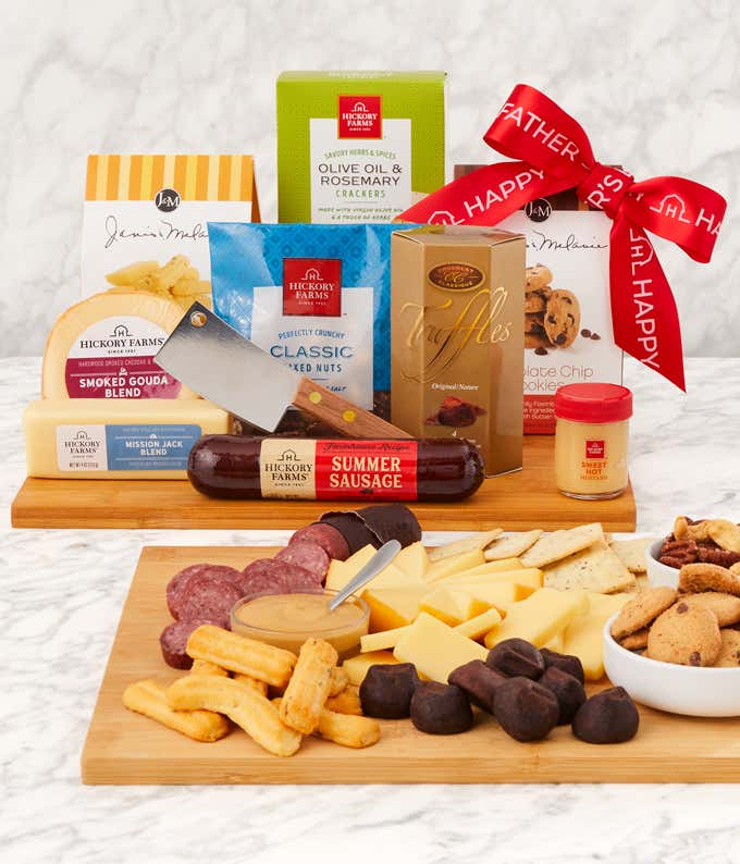 Fathers Day gift set with summer sausage, smoked gouda and Mission Jack cheeses, sweet hot mustard, crackers, cookies, truffles, mixed nuts, and a cleaver, all arranged on a wooden serving board with a red Happy Fathers Day ribbon.
