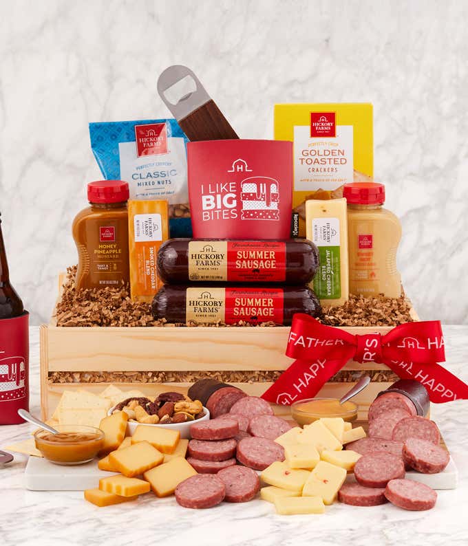 Fathers Day charcuterie gift crate featuring Hickory Farms summer sausage, assorted cheeses, mustards, crackers, mixed nuts, and honey pineapple mustard, with a red I Like Big Bites drink koozie, bottle opener, and red Happy Fathers Day ribbon.