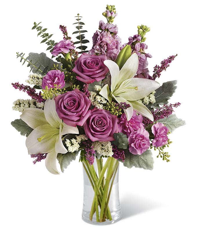 Purple roses, white lilies and mini pink carnations 