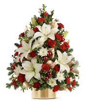 A flower Christmas tree with white and red flowers in a gold vase