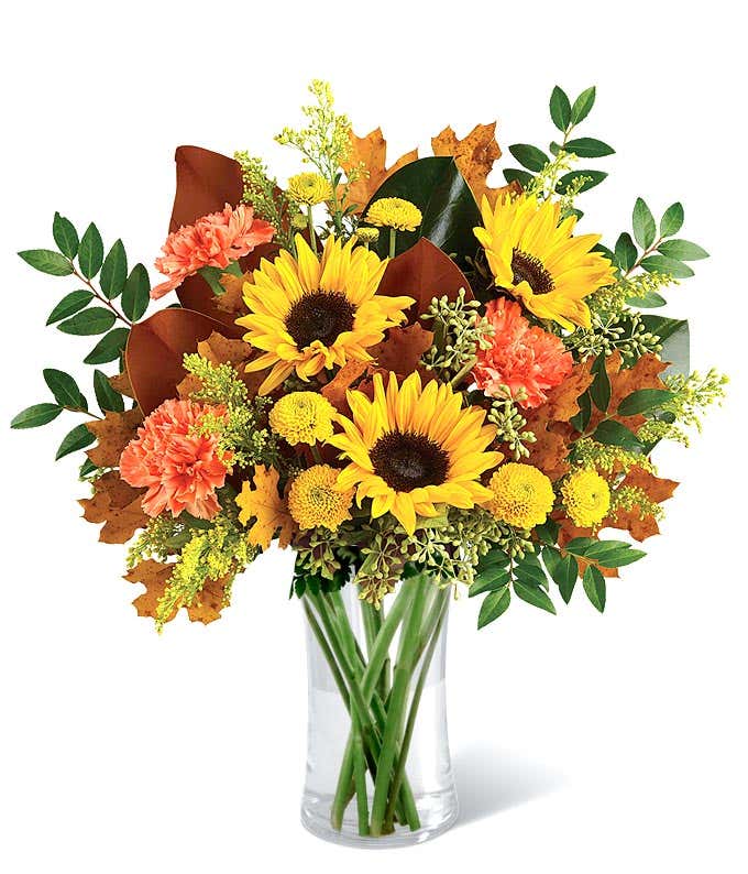 Mixed Fall bouquet with sunflowers, orange carnations and oak leaves