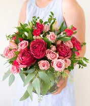 Alternative image 2 for A vibrant floral arrangement featuring pink mini roses, pink alstroemeria, pink mini carnations, a succulent plant, and hot pink roses in deluxe and premium versions. This lush pink mix offers a charming and elegant display.
