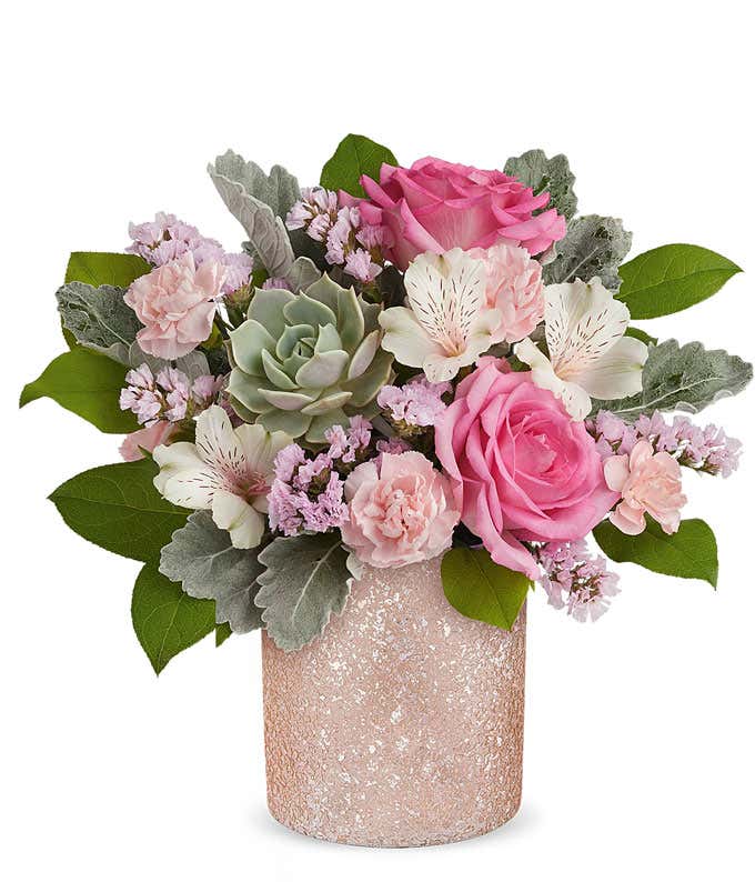 Image of a Mother's Day arrangement featuring Pink Roses, Ivory Alstroemeria, Pink Miniature Carnations, Echeveria Succulent, Pink Sinuata Statice, and floral greenery, presented in a keepsake Pink Shimmer Vase.