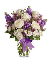 White roses and purple stock in a vase