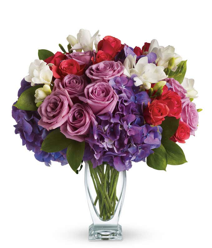 Purple roses with purple hydrangea in a vase