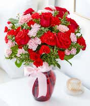 Alternative image 1 for Red roses, pink carnations in a red vase for a romantic bouquet