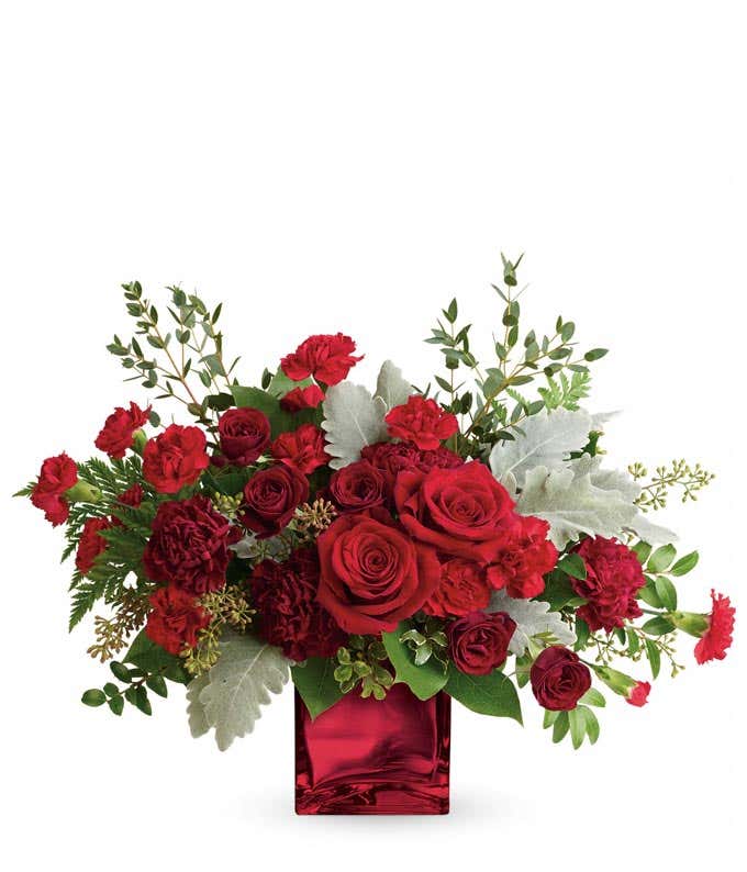 Luxury red rose and red carnations bouquet in a red cube vase