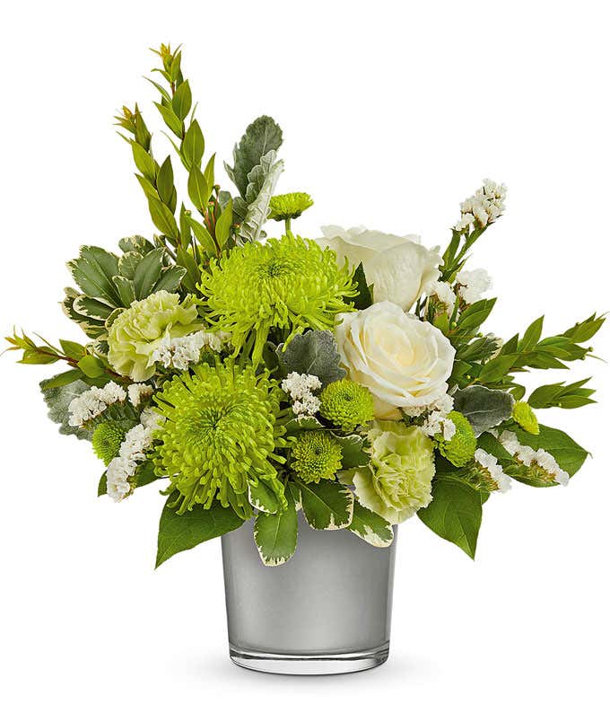  White Roses, Green Carnations, and Chrysanthemums in a Silver Glass Cylinder Vase, accented with Floral Greens.