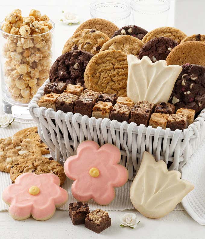 A beautifully arranged Mother's Day gift basket filled with an indulgent assortment of treats, including cookies, brownie bites, frosted cookies, and toffee nut popcorn. Perfect for celebrating Mom's special day!