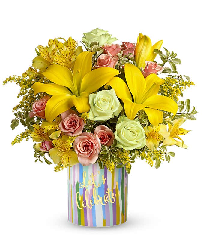 Green roses combined with peach roses, yellow Asiatic lilies, yellow alstroemeria, solidago, and pitta negra, arranged in a keepsake 